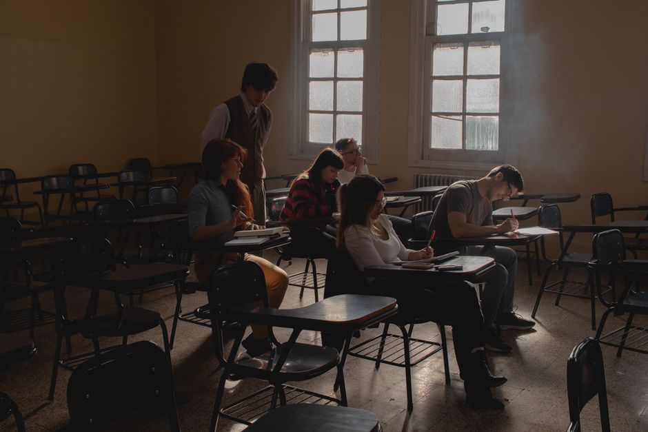A classroom setting where a Deaf instructor is teaching students sign language, emphasizing interactive visual communication.